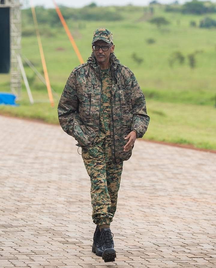 a man in camouflage walking down a brick road