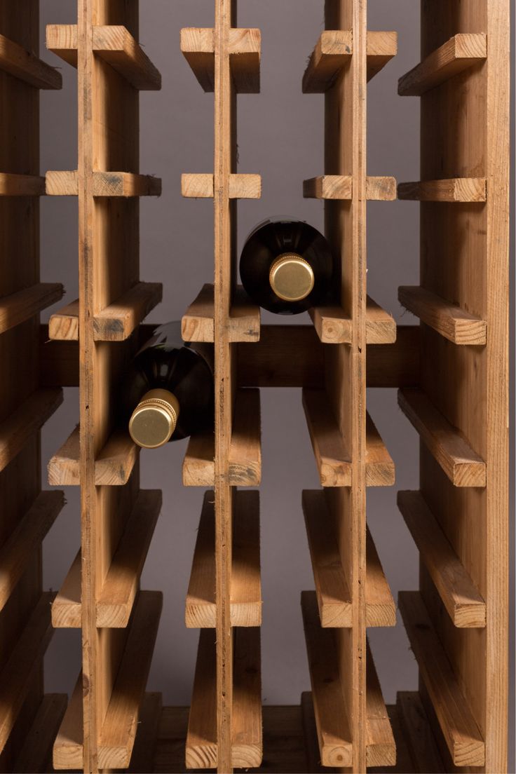 a wooden wine rack with several bottles in it and two on the top shelf for storage