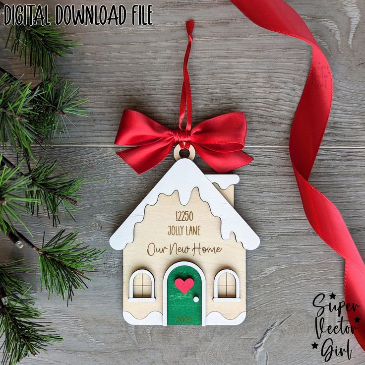 a personalized christmas ornament hanging from a red ribbon on a wooden table