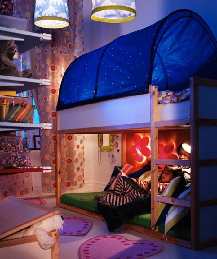 a bunk bed is lit up with blue lights in the corner and pink rugs on the floor