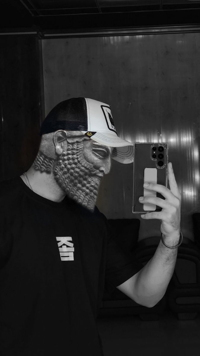 a man wearing a face mask taking a selfie with his cell phone