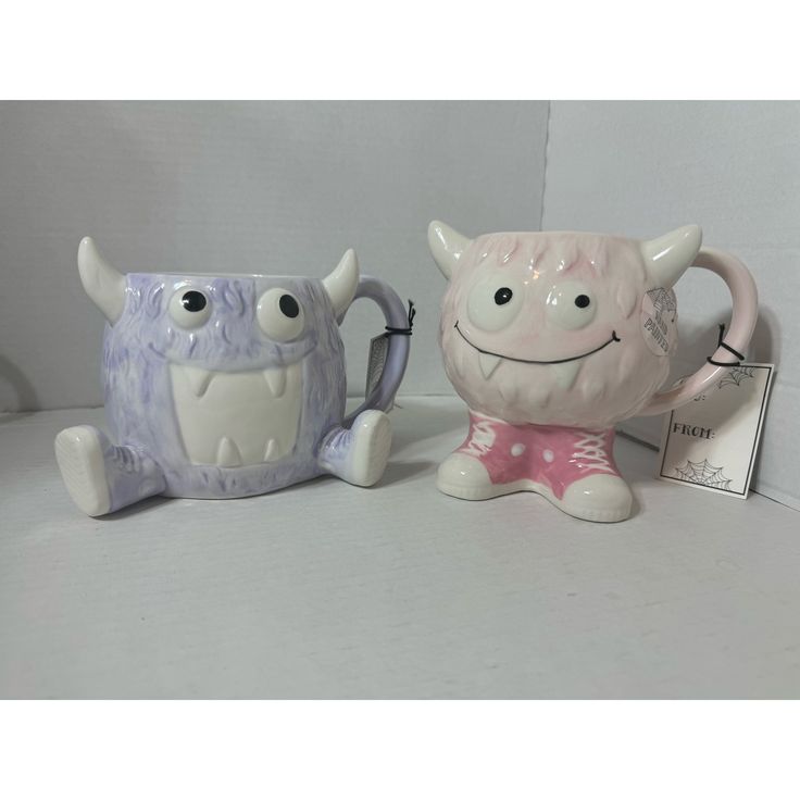 two ceramic monsters sitting next to each other