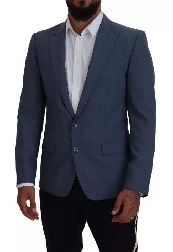 This Dolce & Gabbana blazer, made in Italy, features a blue inner lining and is crafted with a mix of high-quality materials, including 92% wool, 7% elastane, and 1% polyester. The single-breasted style, two-button closure, and logo details make for a sleek and sophisticated look. The lining is composed of 36% cupro, 33% rayon, and 31% acetate for added comfort and durability. Model: Blazer jacket sport Style: Single breasted Color: Blue Blue inner lining Two button closure Logo details Made in Luxury Blue Blazer For The Office, Luxury Blue Blazer For Office, Luxury Blue Office Blazer, Blue Blazer With Suit Collar For Winter, Winter Blue Blazer With Suit Collar, Luxury Blue Outerwear With Single Button, Blue Winter Blazer With Suit Collar, Luxury Single-button Blue Outerwear, Blue Single-button Wool Outerwear