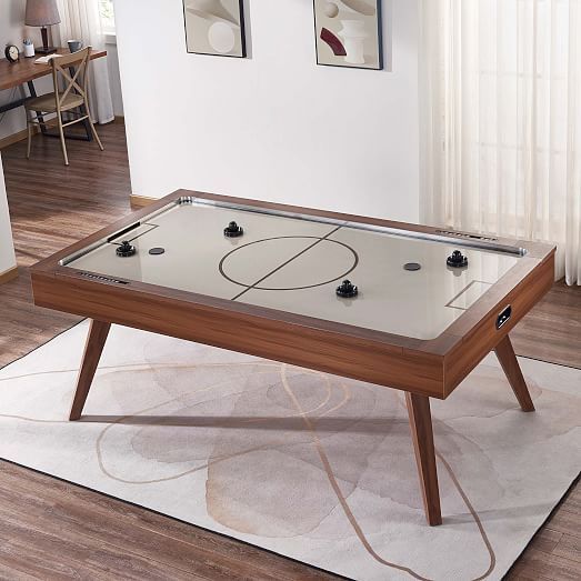 a table with a basketball game on it in the middle of a living room area