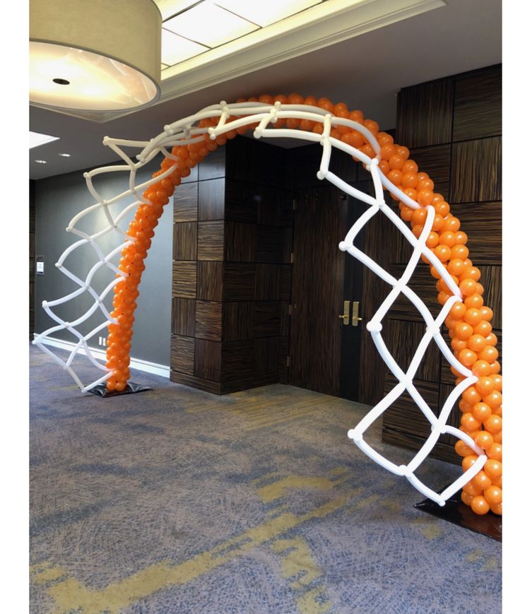 an arch made out of balloons in the middle of a room