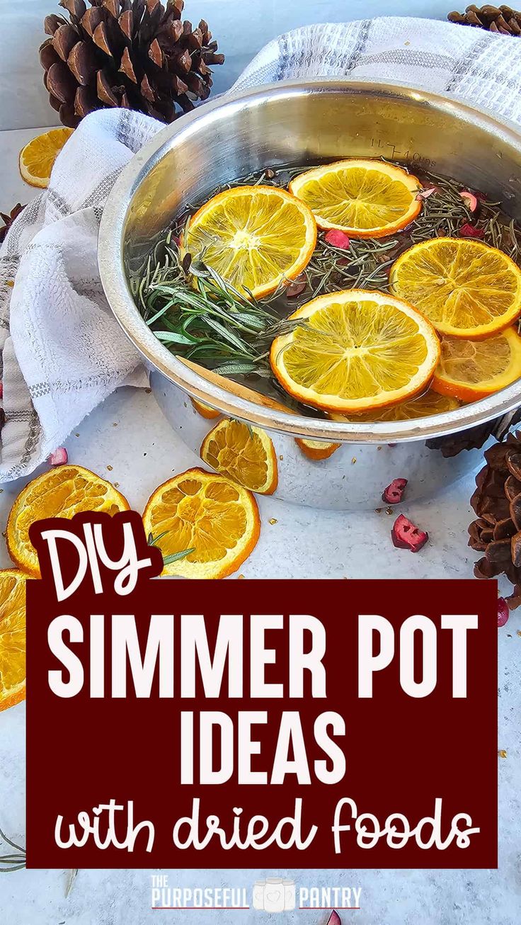 a pot filled with oranges and herbs on top of a table next to pine cones