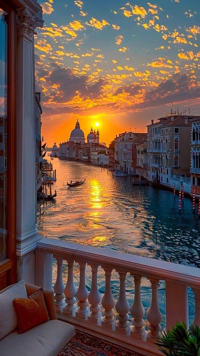 the sun is setting in venice, italy as seen from a balcony overlooking the grand canal