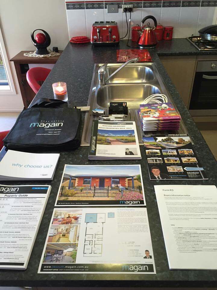 the kitchen counter is covered with pamphlets and other items