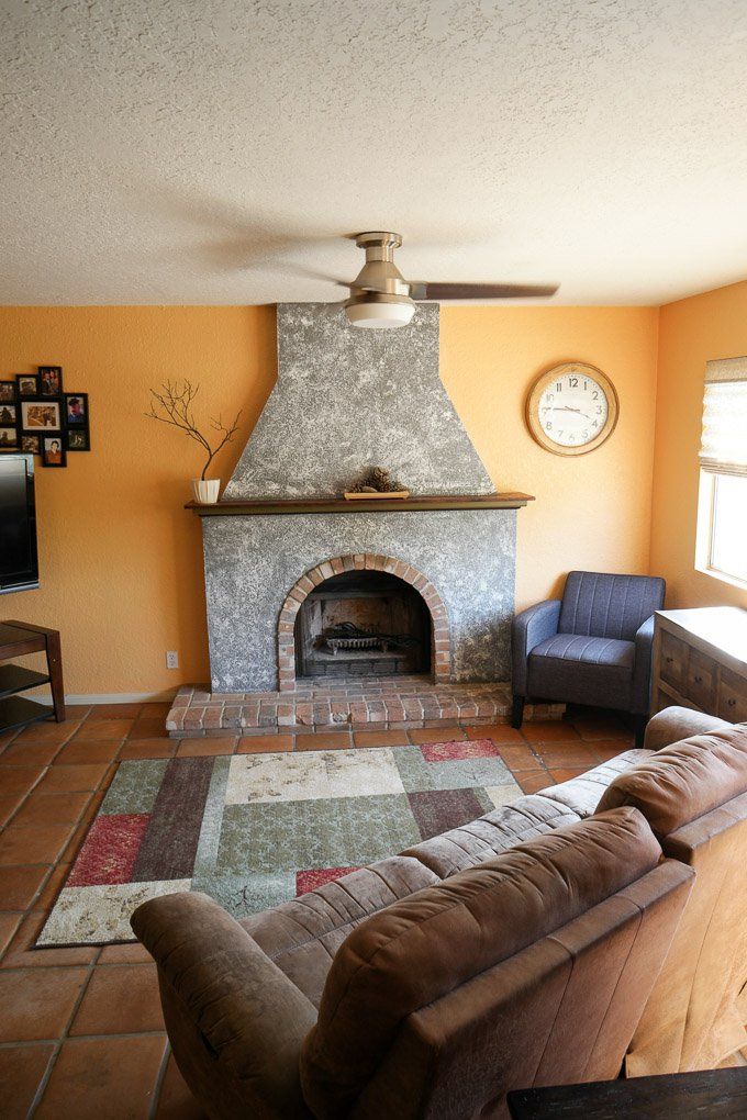 a living room with a fire place and couches