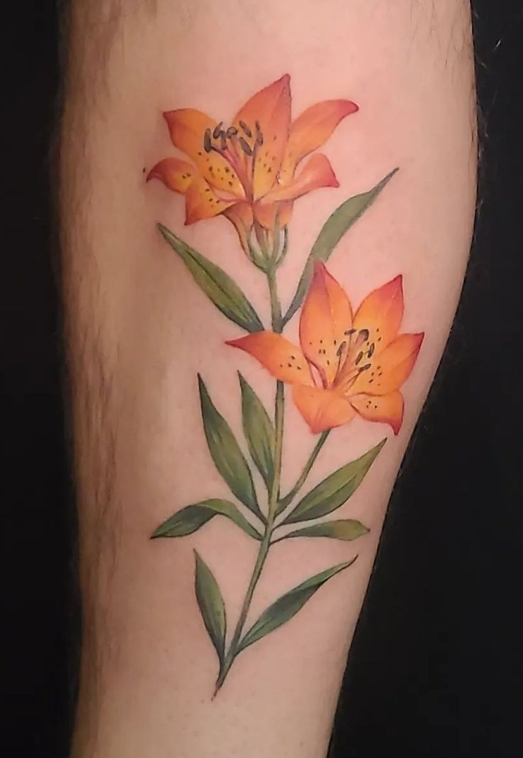 an orange flower with green leaves on the side of her leg, tattoo artist in london