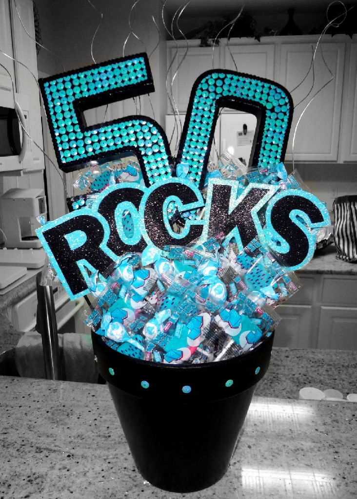 a birthday cake with the number fifty rocks on it