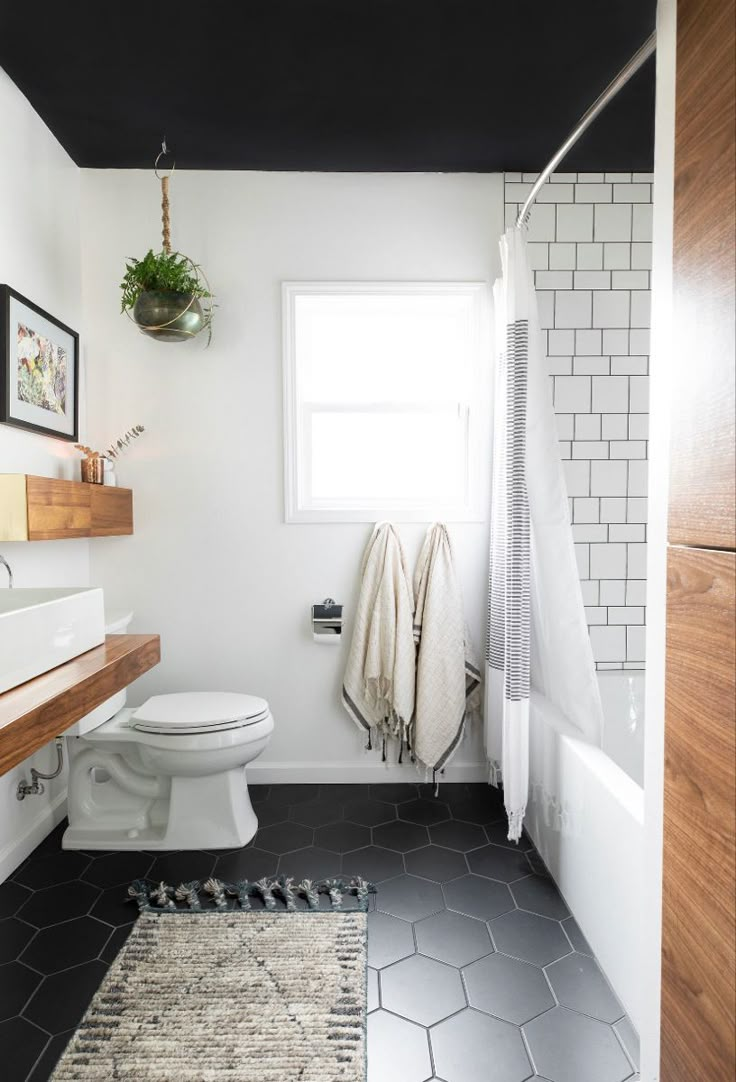 a white toilet sitting in a bathroom next to a window