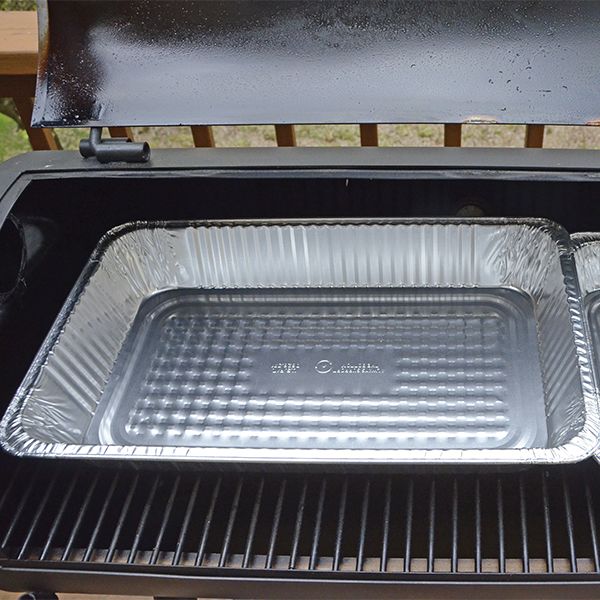 an open grill with two pans on it