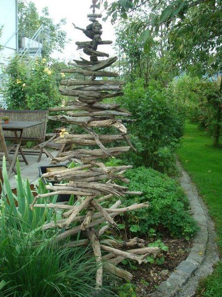 a wooden structure made out of branches in a garden