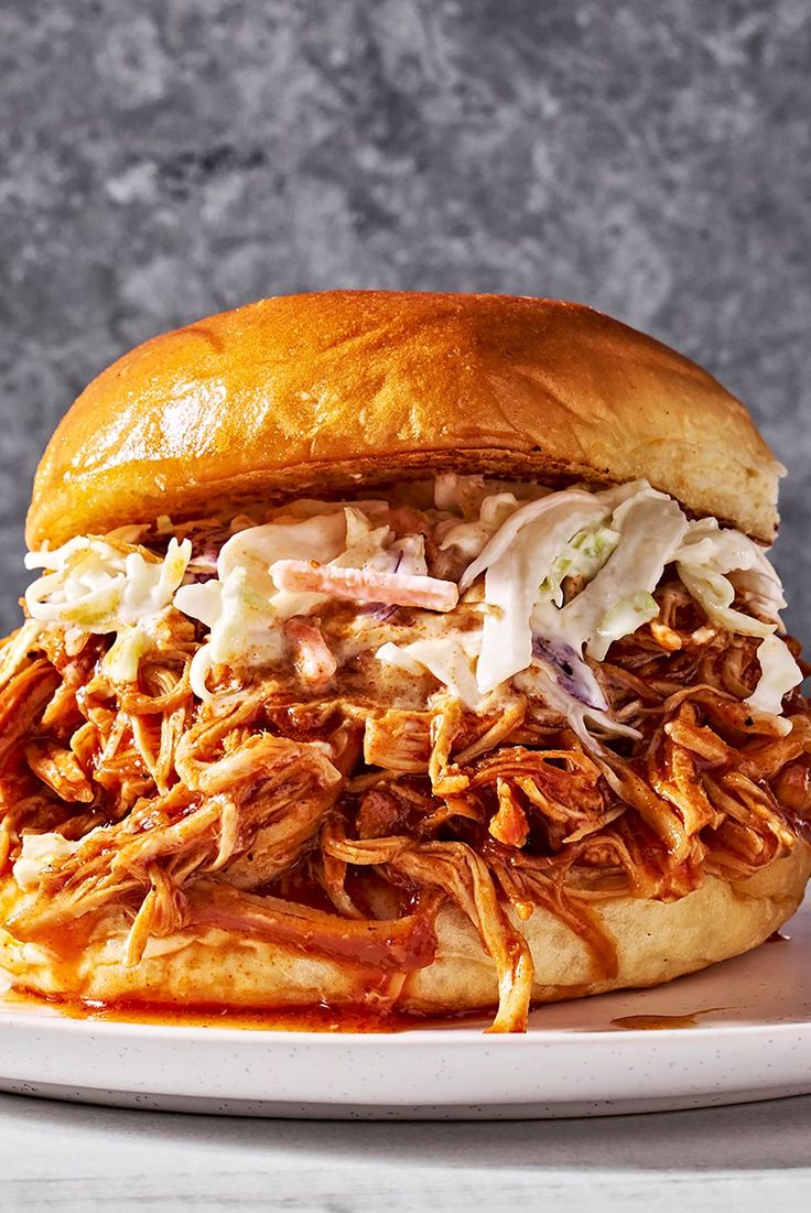 a pulled pork sandwich on a white plate