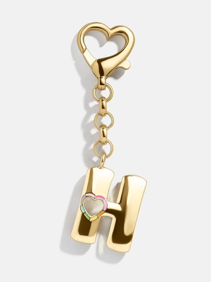 a heart shaped key chain with the letter h hanging from it's center, on a white background