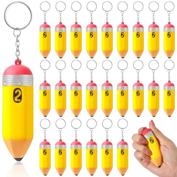 a hand holding a yellow pencil with numbers on it next to a set of key chains