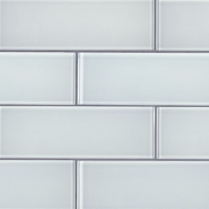 a close up view of a white tile wall