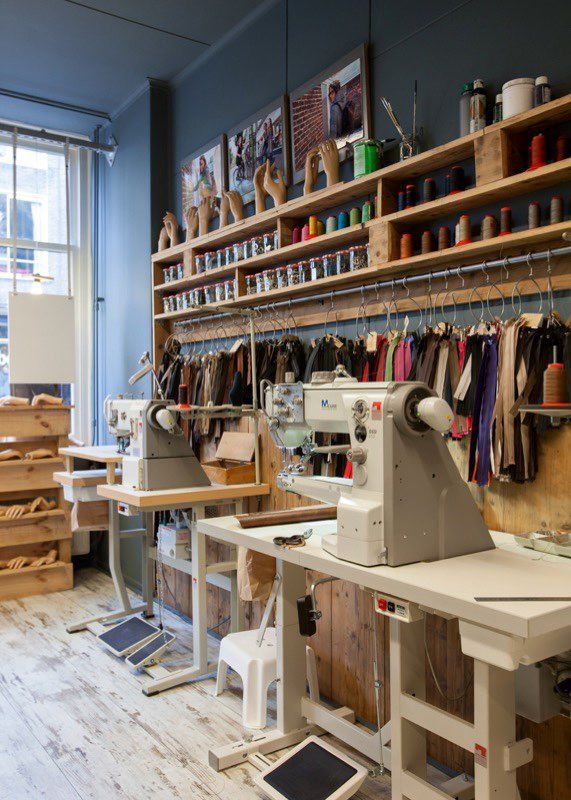 a sewing studio with lots of crafting supplies on the shelves and in front of a window