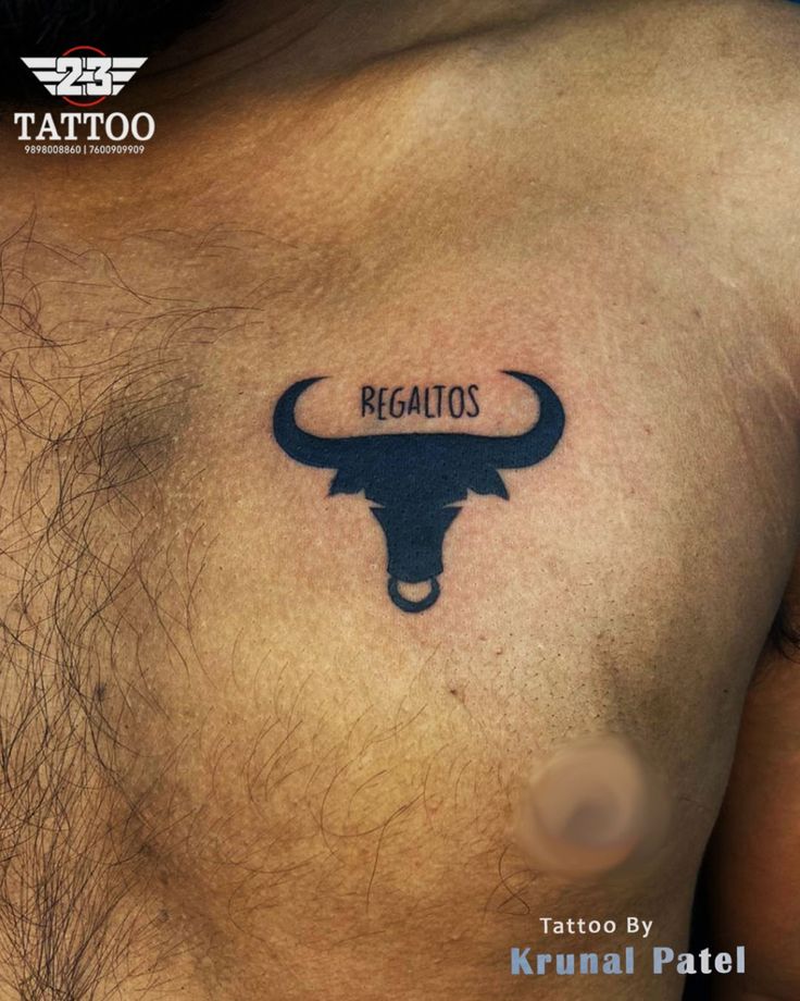 a bull's head with the word regalios tattooed on its chest is shown