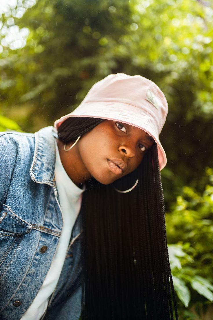 pink bucket hat on girl with long box braids and silver hoop earrings. wearing a denim jacket. Pink Hip Hop Style Cotton T-shirt, Pink Casual T-shirt, Hat And Braids, Big Hair Styles, Pink Bucket Hat, Brown Satin, Bucket Hats, Big Hair, Bucket Hat