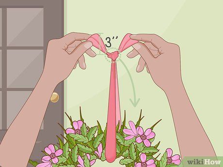 two hands holding a wreath with pink flowers and the number 3 on it in front of a door