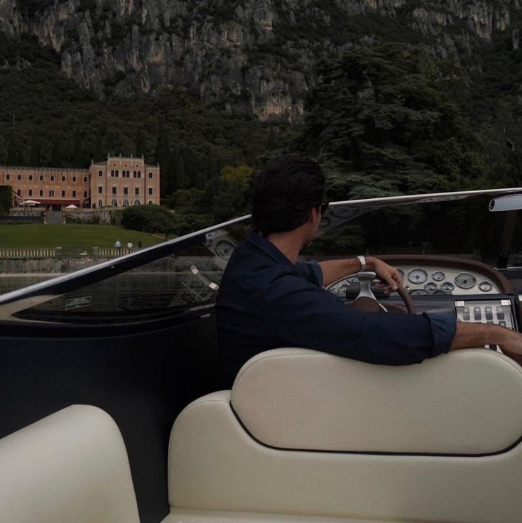 a man driving a boat on a body of water