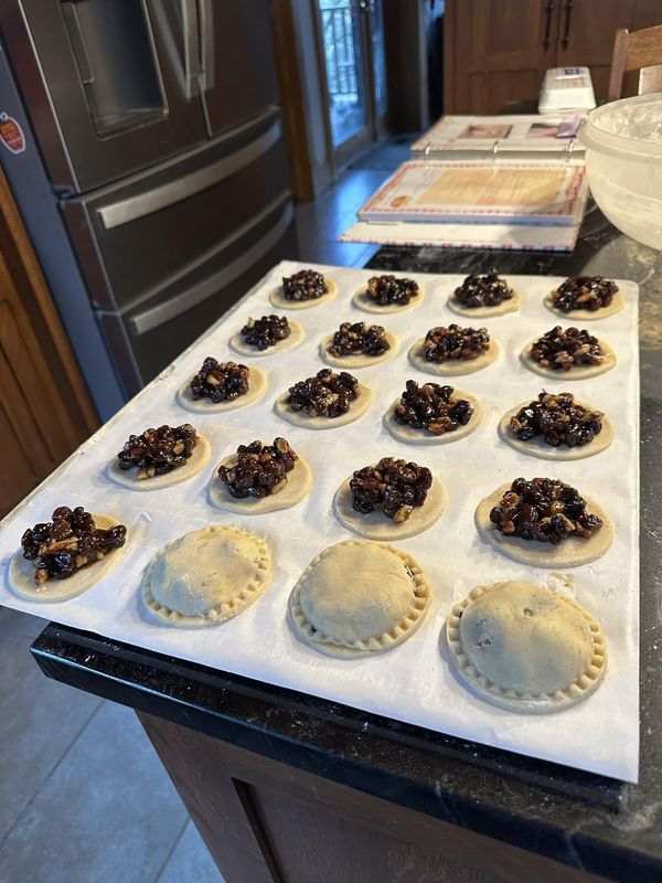 many pastries are on a baking sheet ready to go into the oven for bake