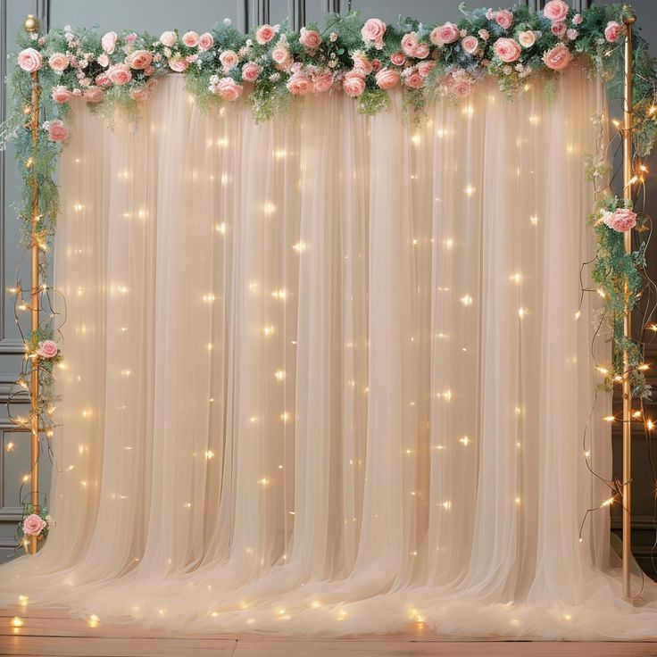 the backdrop is decorated with pink flowers and greenery for a wedding or special event