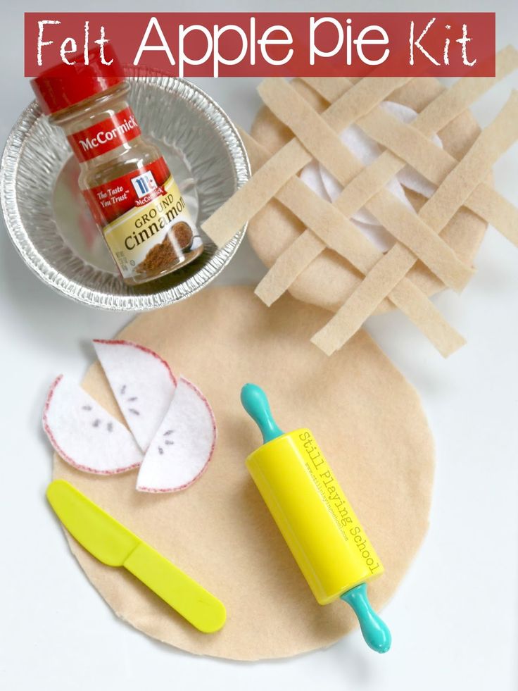 an apple pie is cut into pieces and placed on a paper plate next to scissors