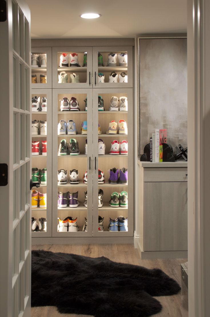 a walk in closet filled with lots of shoes