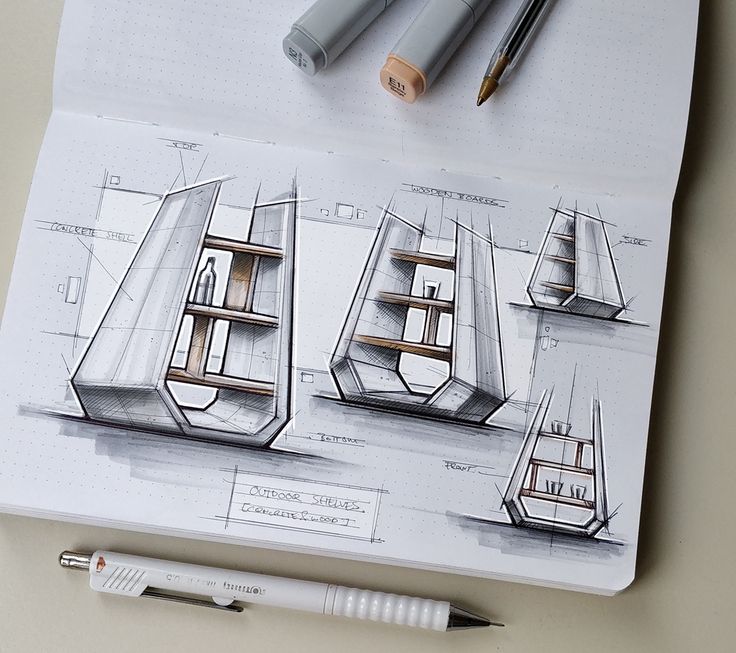 some drawings and pens on top of a piece of paper