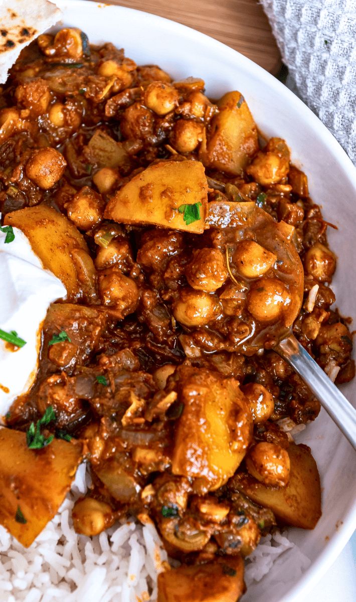 a white bowl filled with food and rice