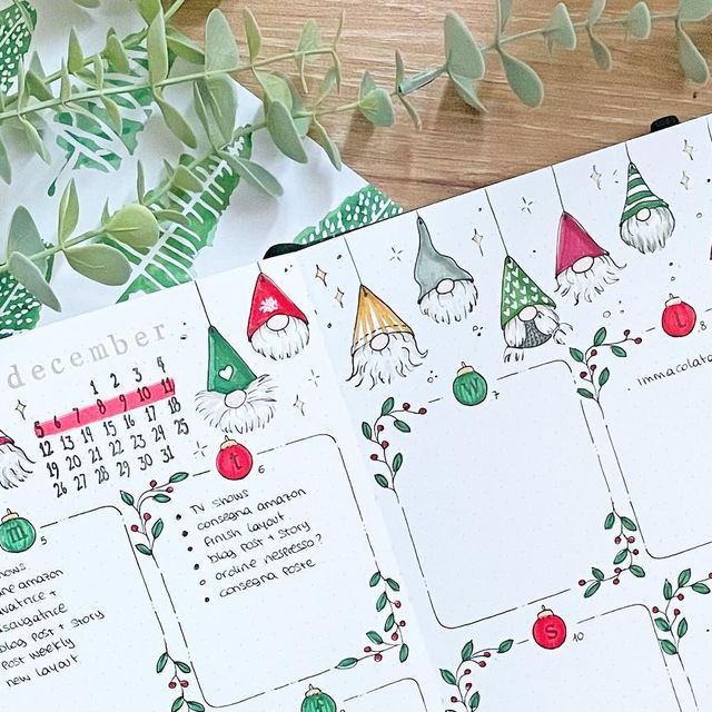 a calendar with gnomes on it sitting next to some plants and leaves in the background