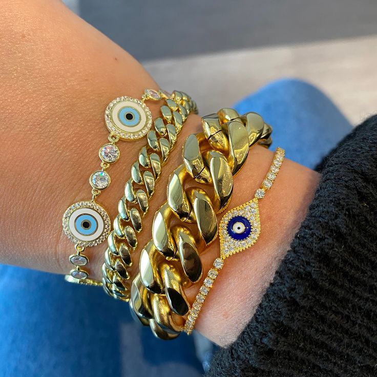 Like a sweet guardian angel for your wrist, this sparkle-starred evil eye bracelet is ready to work overtime to keep good vibes flowing your way! A chain of sky blue nazars, each lined in bright gold and crowned with a heavenly halo of gems, is kept company by brilliant crystals for an extra dose of illumination. Charming, effortlessly graceful, and a constant companion for your everyday adventures. 14k gold plated sterling silver Clear crystals 6-7" Adjustable in length Gold Cubic Zirconia Jewelry With Evil Eye Detail, Gold Cubic Zirconia Jewelry With Evil Eye, Evil Eye Cubic Zirconia Bracelet, Trendy Gold Evil Eye Bracelet Gift, Trendy Gold Bracelets With Evil Eye, Trendy Blue Bracelets With Adjustable Chain, Trendy Evil Eye Jewelry Gift, Trendy Everyday Evil Eye Jewelry, Gold Beaded Evil Eye Bangle Bracelet