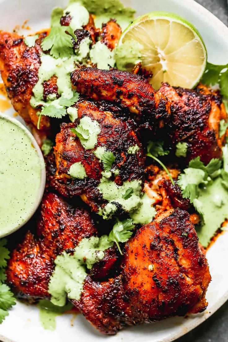 chicken wings with cilantro sauce and garnishes on the side text overlay says easy peruvian chicken