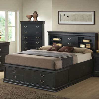 a black bed with drawers underneath it in a room