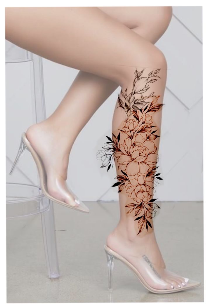 a woman's legs with floral tattoos on them