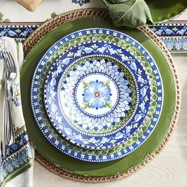 a place setting with blue and green plates