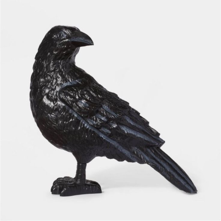 a black bird statue sitting on top of a table