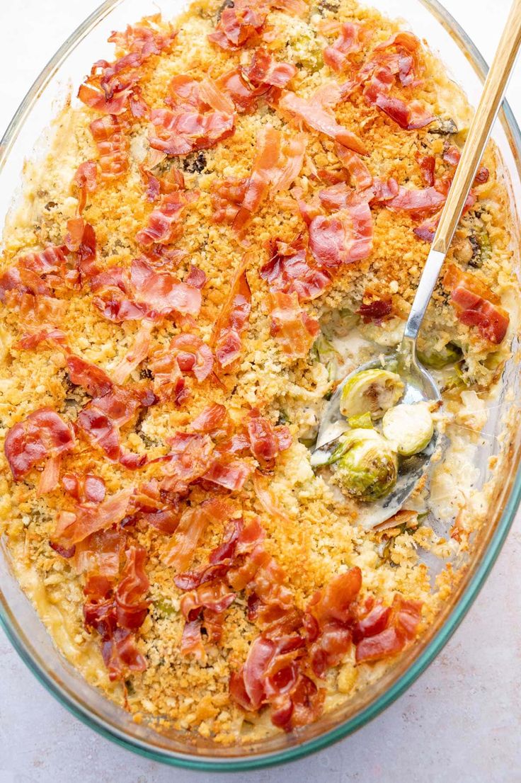 a casserole dish with bacon and broccoli in it, ready to be eaten