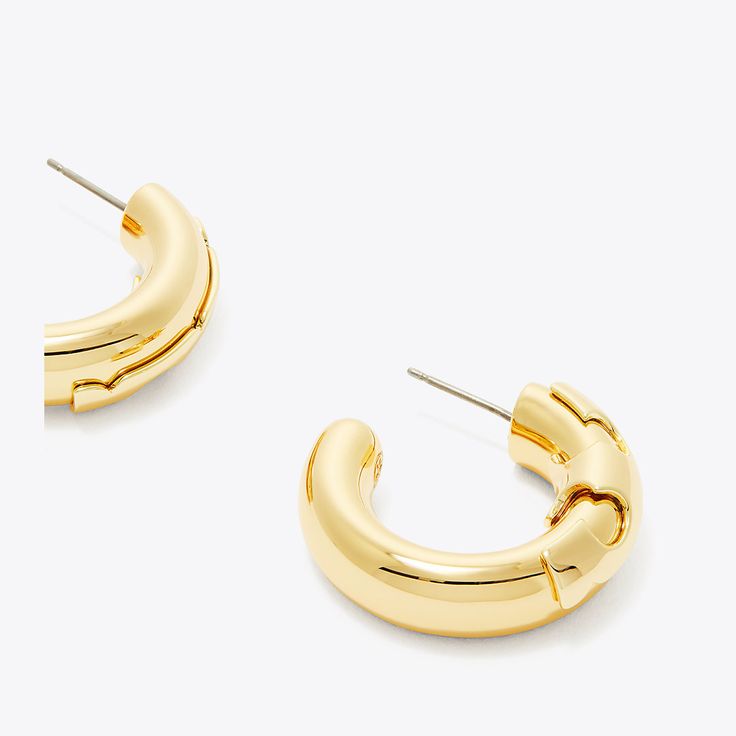 The Essential Hoop features an abstracted Double T in 18k-gold plated brass and crystal. Perfect for every day, paired with other pieces from the collection or mixed with other styles. Modern Plated Hoop Earrings, Luxury Gold-tone Metal Hoop Earrings, Modern Gold Hoop Earrings With Shiny Finish, Modern Metal Earrings With Gold-tone Hardware, Luxury Gold-tone Hoop Earrings, Gold Small Hoop Contemporary Earrings, Gold-tone Polished Metal Hoop Earrings, Modern Gold-plated Hoop Earrings, Modern Gold Metal Hoop Earrings