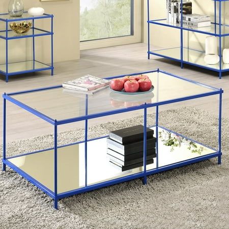 three glass tables with books on them in a living room