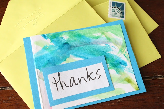 a thank card with the word thanks written on it next to some yellow envelopes