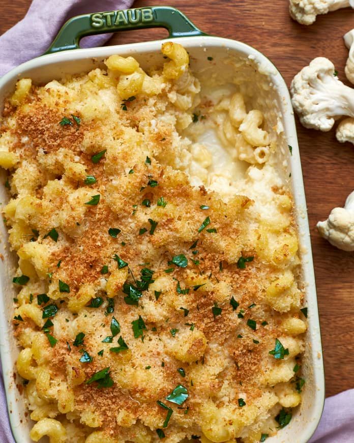 a casserole dish with macaroni and cheese in it on a wooden table