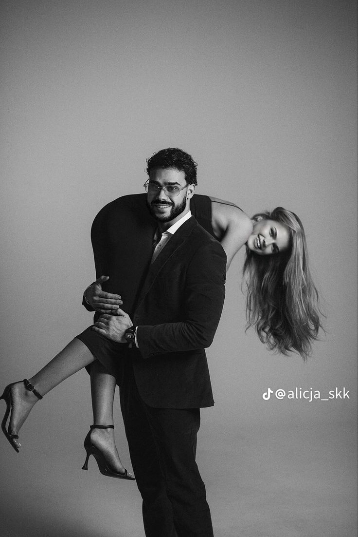 a man and woman are posing for a black and white photo with their arms around each other