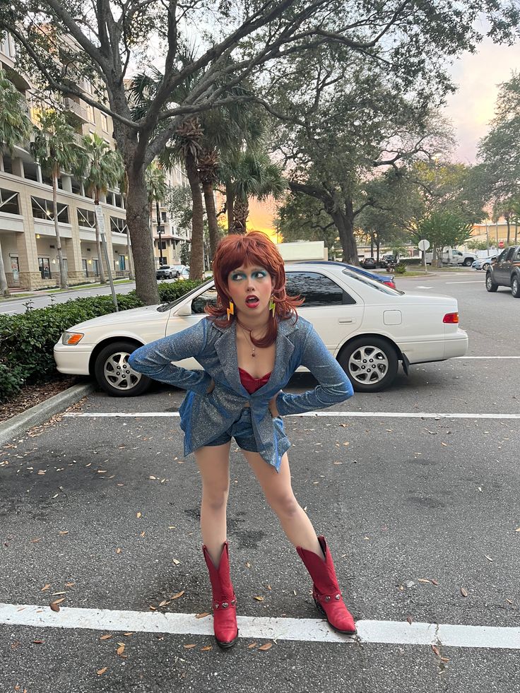 a woman with red hair is standing in the street