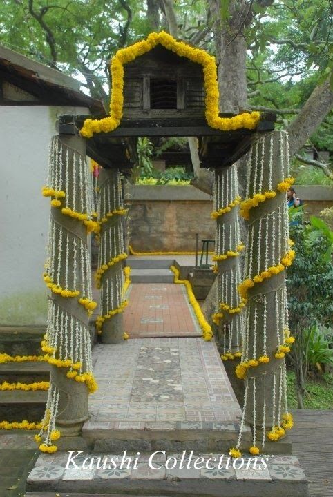 an outdoor shrine with yellow flowers on it