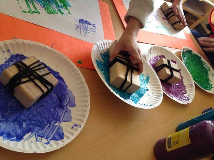 two paper plates with brownies on them, one being dipped in blue and green paint