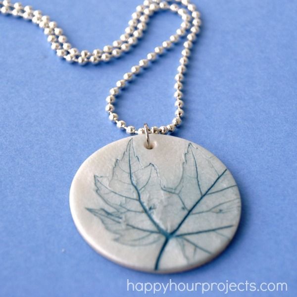 a necklace with a leaf etched on it